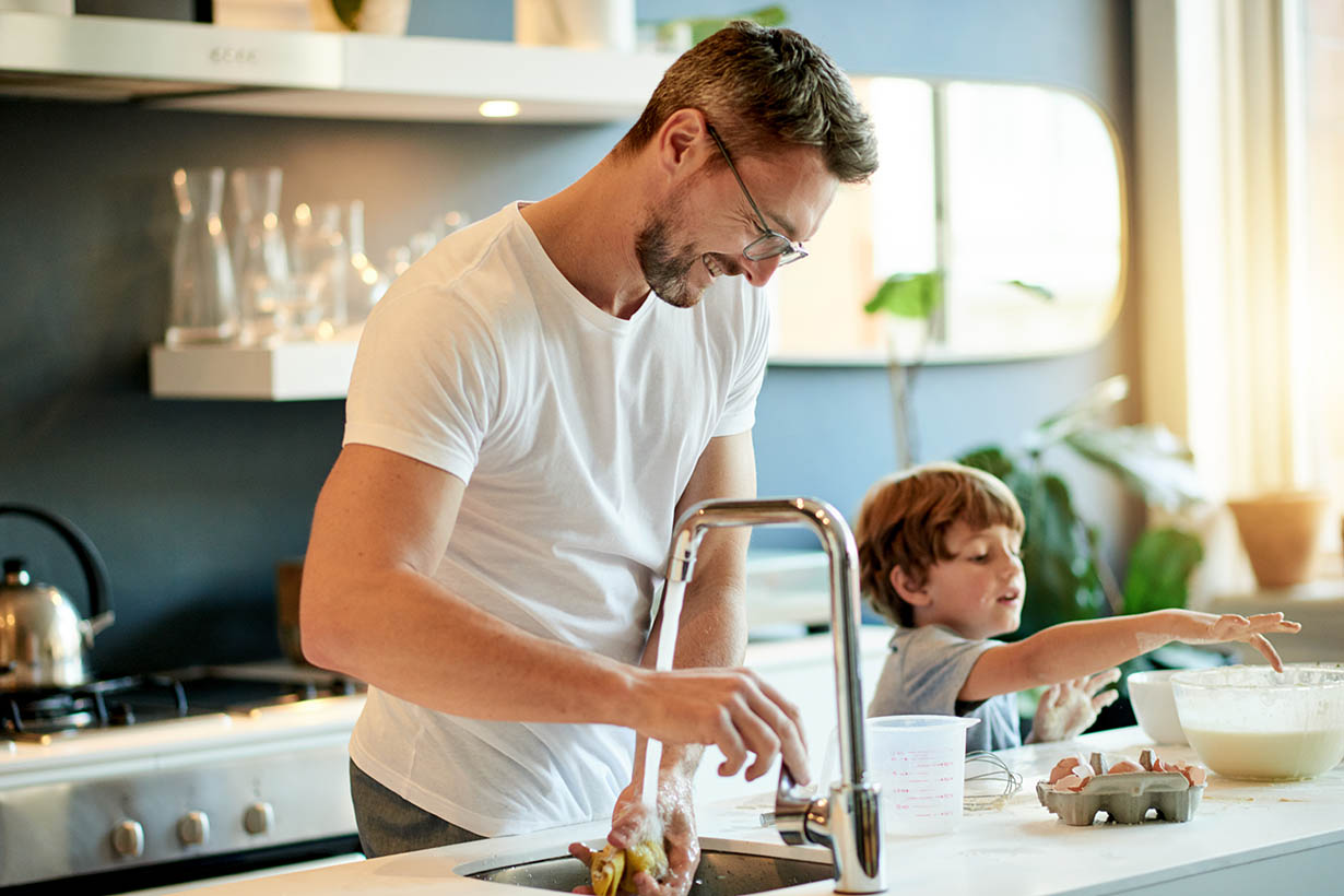 father and son cooking at the counter