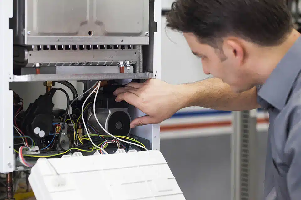 HVAC technician servicing heating boiler