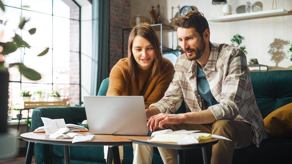 Doing Accounting at Home: Happy Couple Using Laptop Computer, Si blog GuideTaxCredit 1 1200x675 1