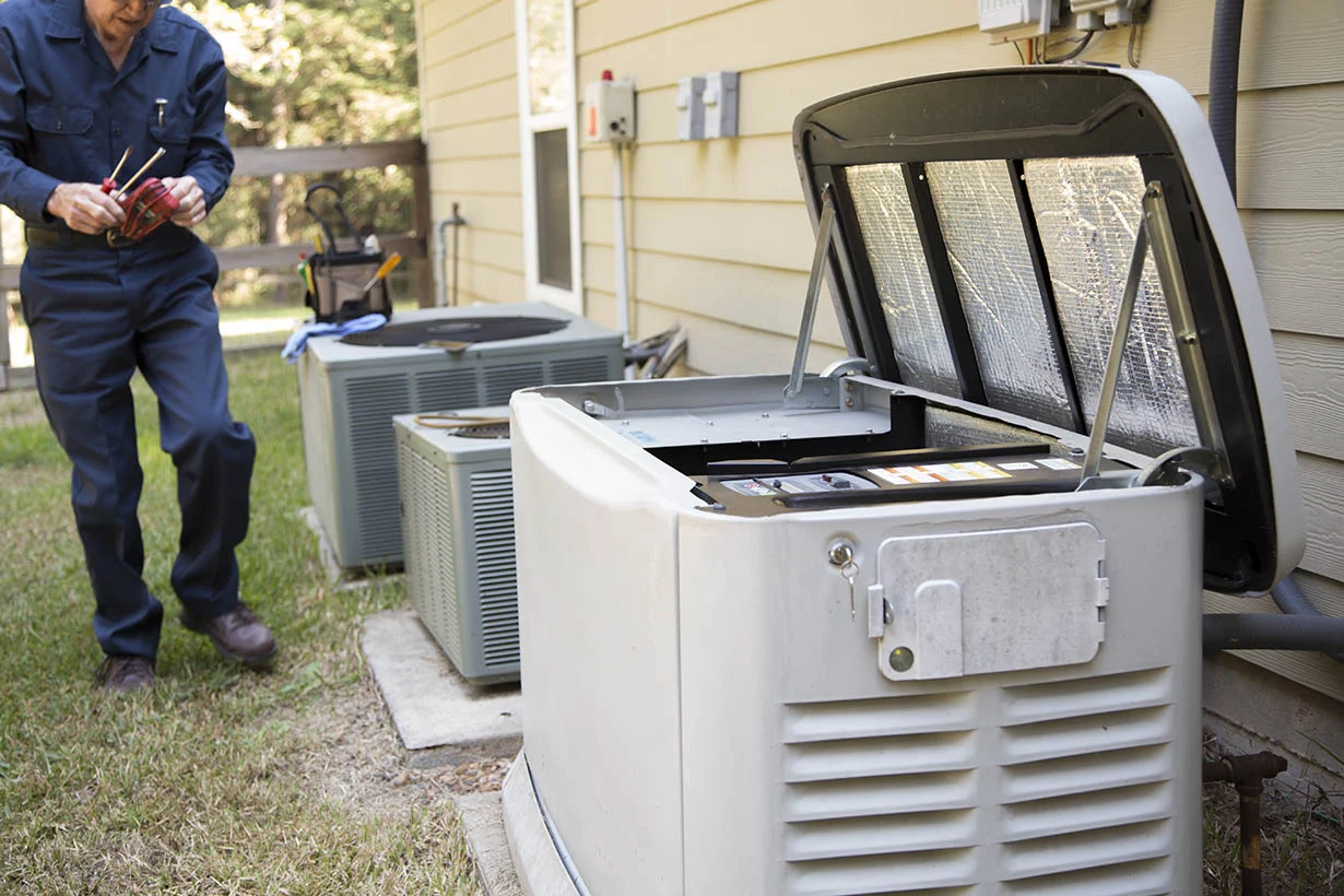Technician services outside AC units and generator.